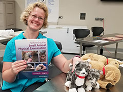 Ryane Englar shows her newly published textbook.