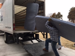 men loading mattresses 