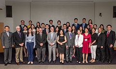 Students in the program pose for a group photo with visitors and VIPs for the event.