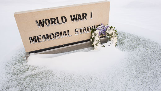 A wreath is set by the World War I Memorial Stadium sign.