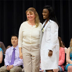 Dr. Laurie Beard celebrates with Amanda Jones on receiving her coat during the 2018 White Coat ceremony.  