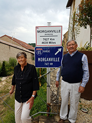 Margretta (Flinner) Fosse and Jay Mellies, both of whom participated in the 1948 pageant play in Morganville that raised money for war-devastated Fèves, France, are standing next to the city office building in Morganville's sister city. 
