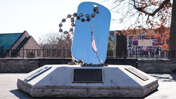 Flag reflection in World War II Memorial on campus 