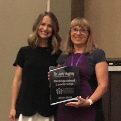 Judy Hughey, right, is presented with the Distinguished Leadership Award. 