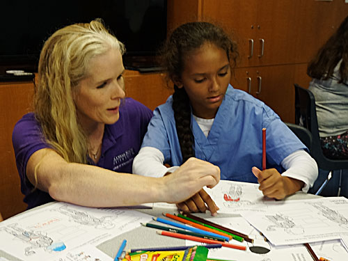 Dr. Kate KuKanich works with a student at the Boys & Girls Club of Manhattan