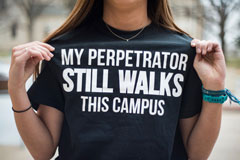 Wildcats Against Sexual Violence President Paige Eichkorn stands outside of the Student Union holding her “My Perpetrator Still Walks This Campus” shirt. Eichkorn custom made the shirt at Thread in Aggieville. The shirt was made in order to raise awarenes