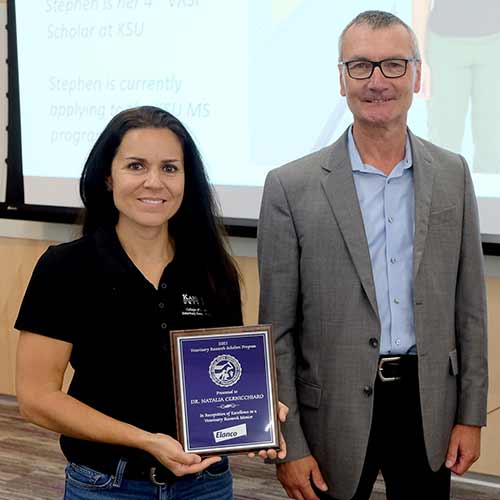 Dr. Natalia Cernicchiaro receives mentoring award from Dr. Ernst Heinen, vice president of clinical operations and technical development at Elanco.