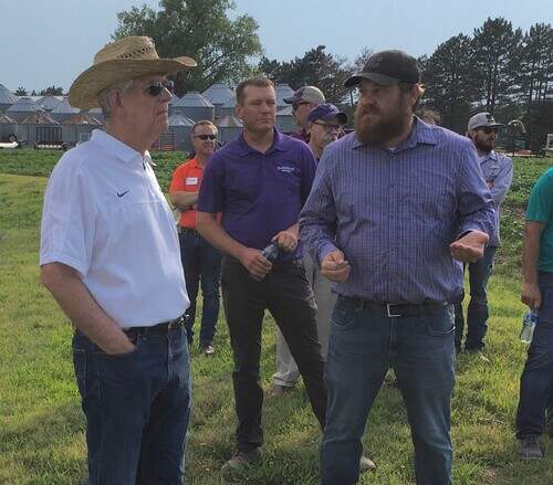 Nathan Hein presents field phenotyping facilities to President Myers at the North Farm