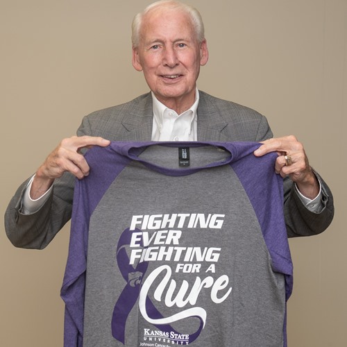 Bill Snyder holding 2021 Fighting for a Cure shirt