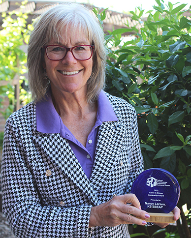 Nancy Larson holds Karen V Brown Award