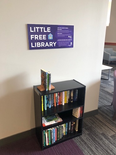 The Little Free Library is located on the second floor of Hale Library, near the soft seating area above the famous sunflower entrance.