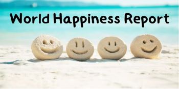 Beach of stones spelling out World Happiness Report 2023