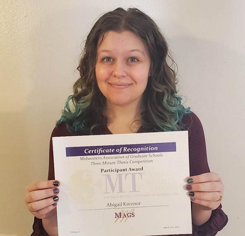 Abby Kreznor holding 3MT regional participation certificate