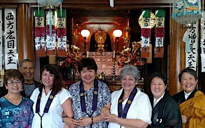 Dr. Jessica Falcone poses with friends in front of altar