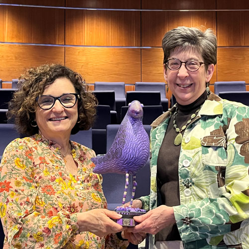 Rebeca Paz, left, and Jeannie Brown Leonard with the Purple Reign trophy.