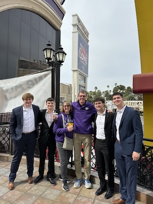 K-State students Michael Jacobson, Colby Osner, Evan Giles, and Caleb Conyers pose with alumni Scott and Tresa Burger from Sabetha, KS.