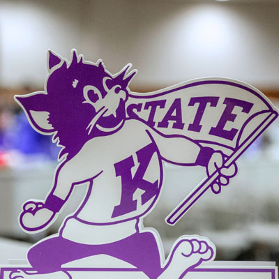 A cutout of Willie Wildcat in front of a conference room