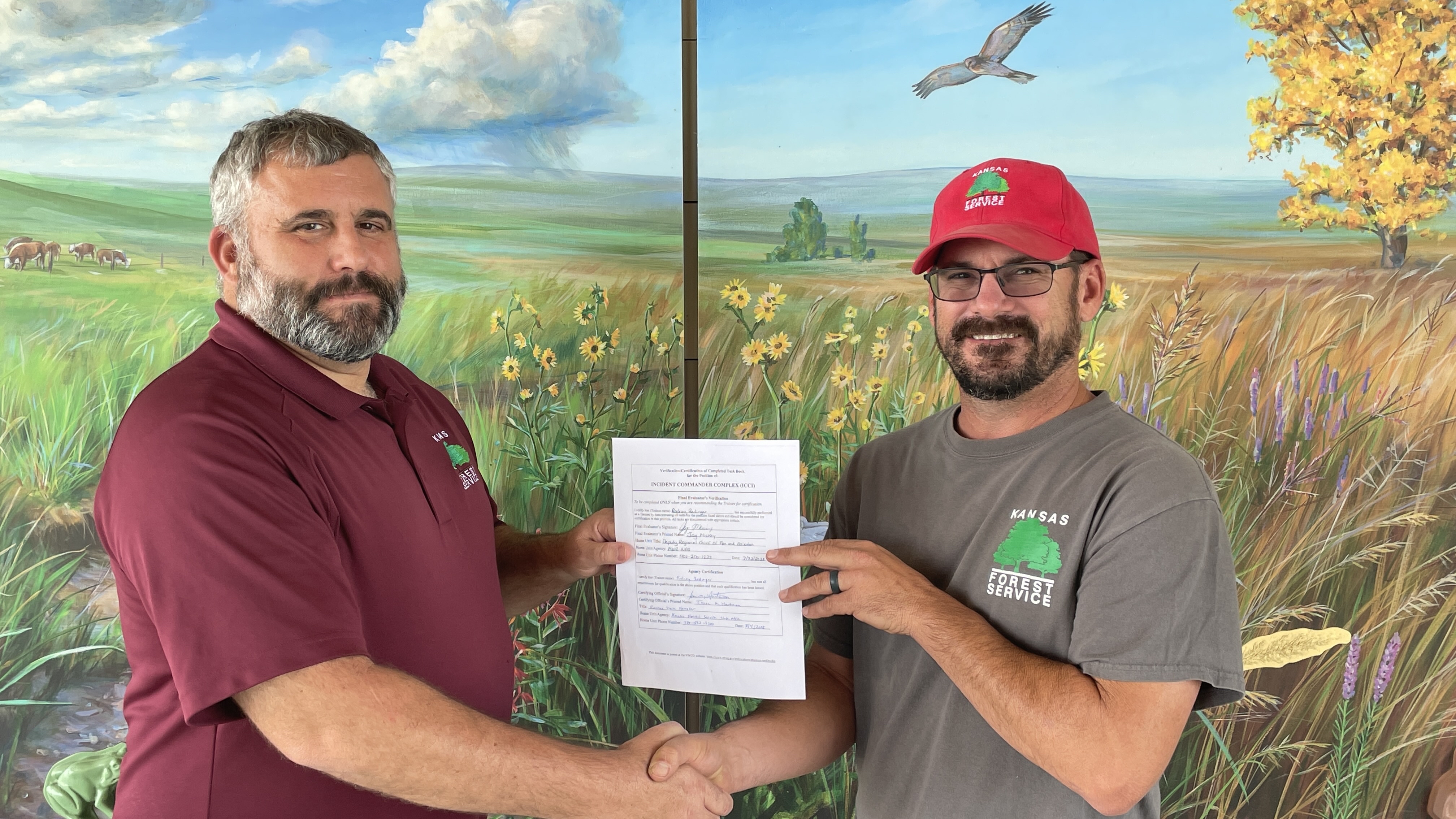 Rodney (right) accepts his certificate from State Forester, Jason Hartman (left)