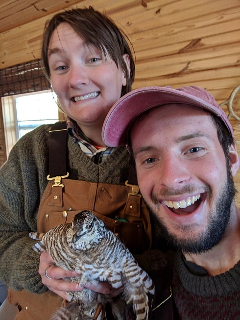 Carly and Liam holding a lesser prairie-chicken