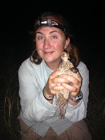 Robinson holding a lesser prairie chicken