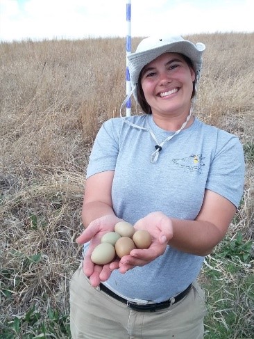 Addie holding phesant eggs