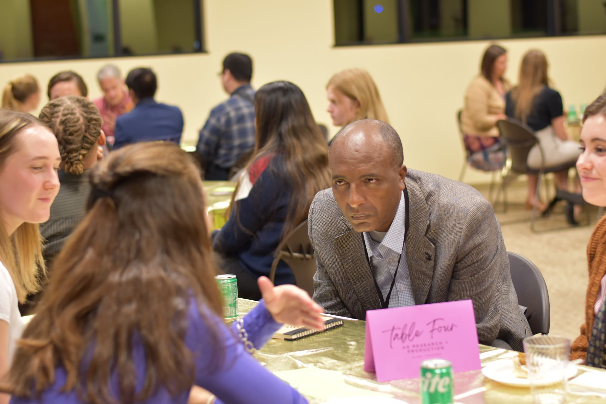 Man leans in for group conversation