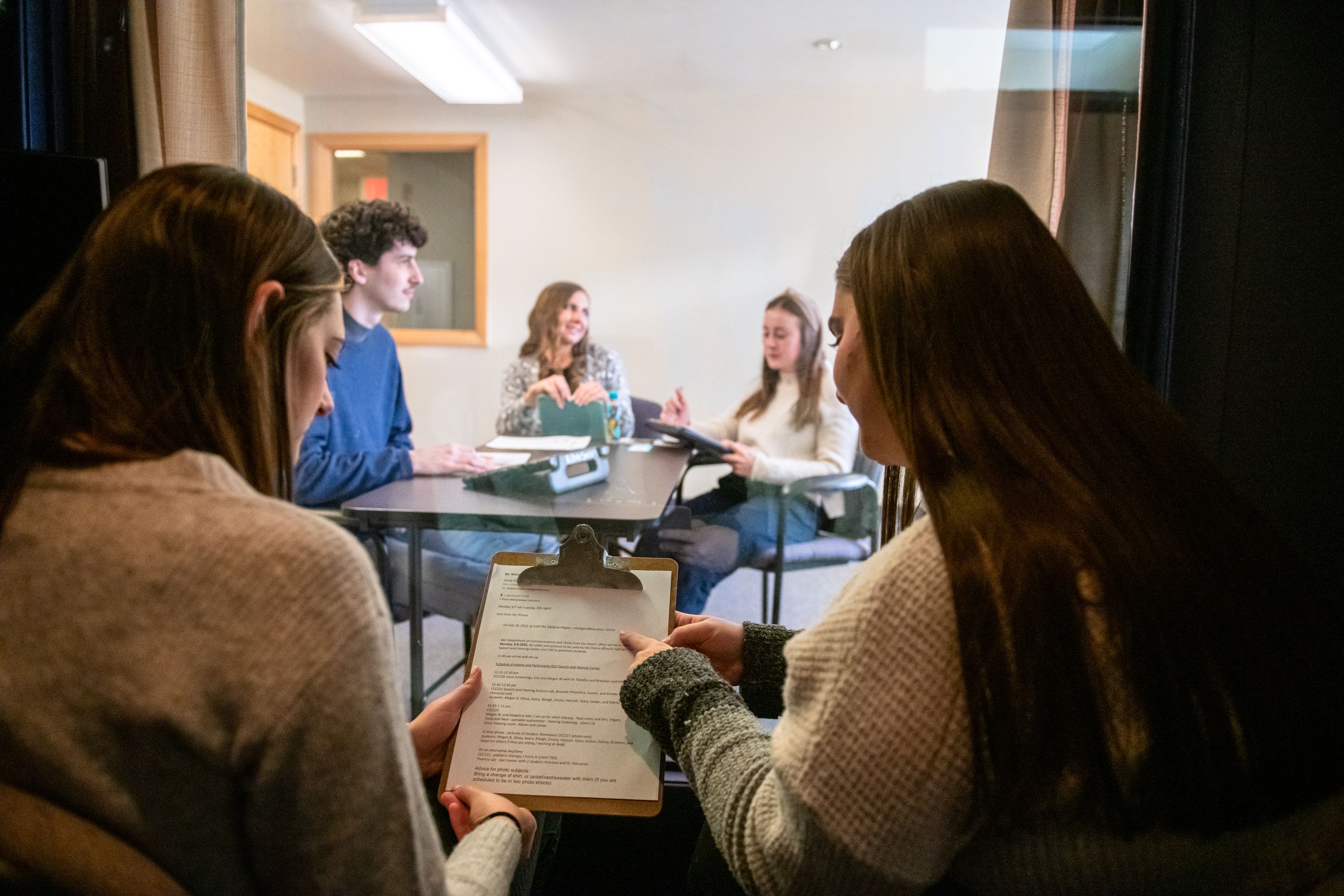 Two students observe a professional.