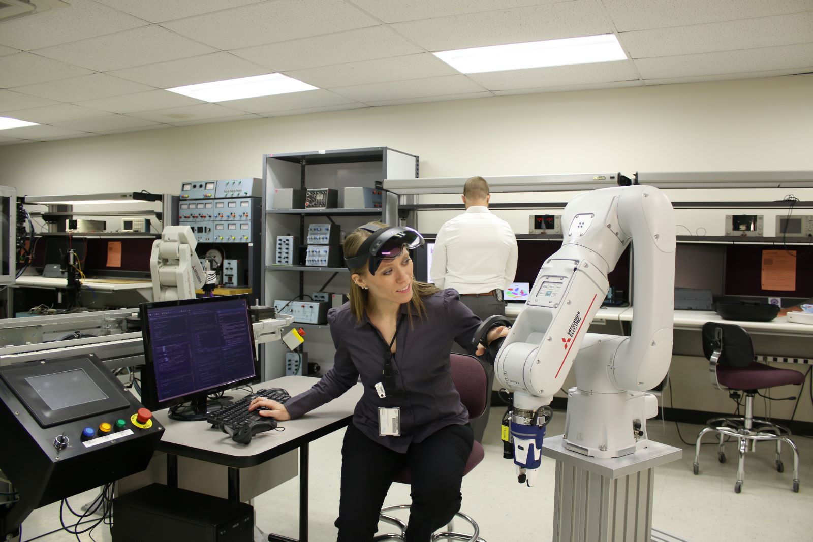 A female student uses a robot.