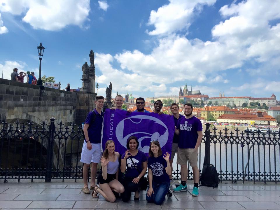 students aboad students in Prague with K-State flag