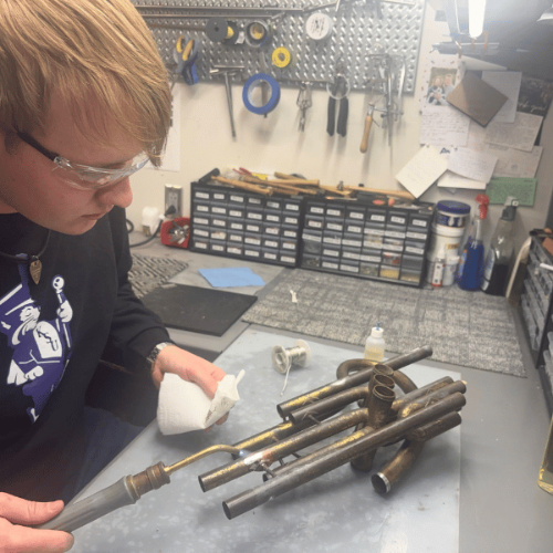 K-State student Chase Wassom in the Instrument repair shop