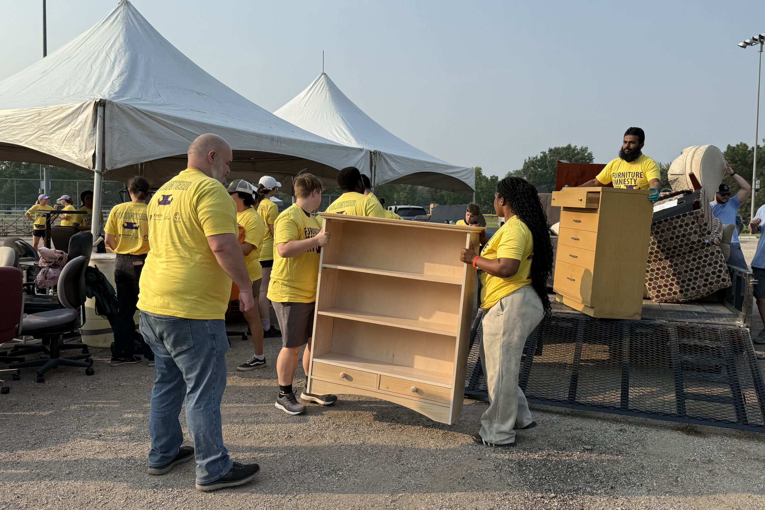 FAD volunteers carrying furniture