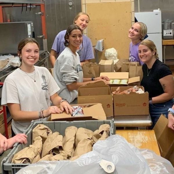 Nonprofit students packing lunches