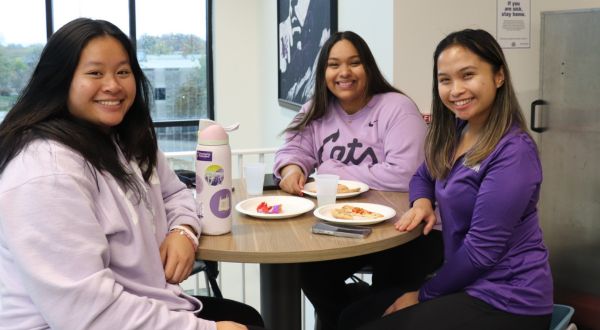 Three students pose for photo