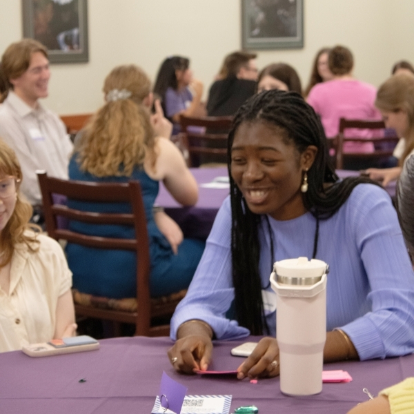 Student laughing in conversation with peers