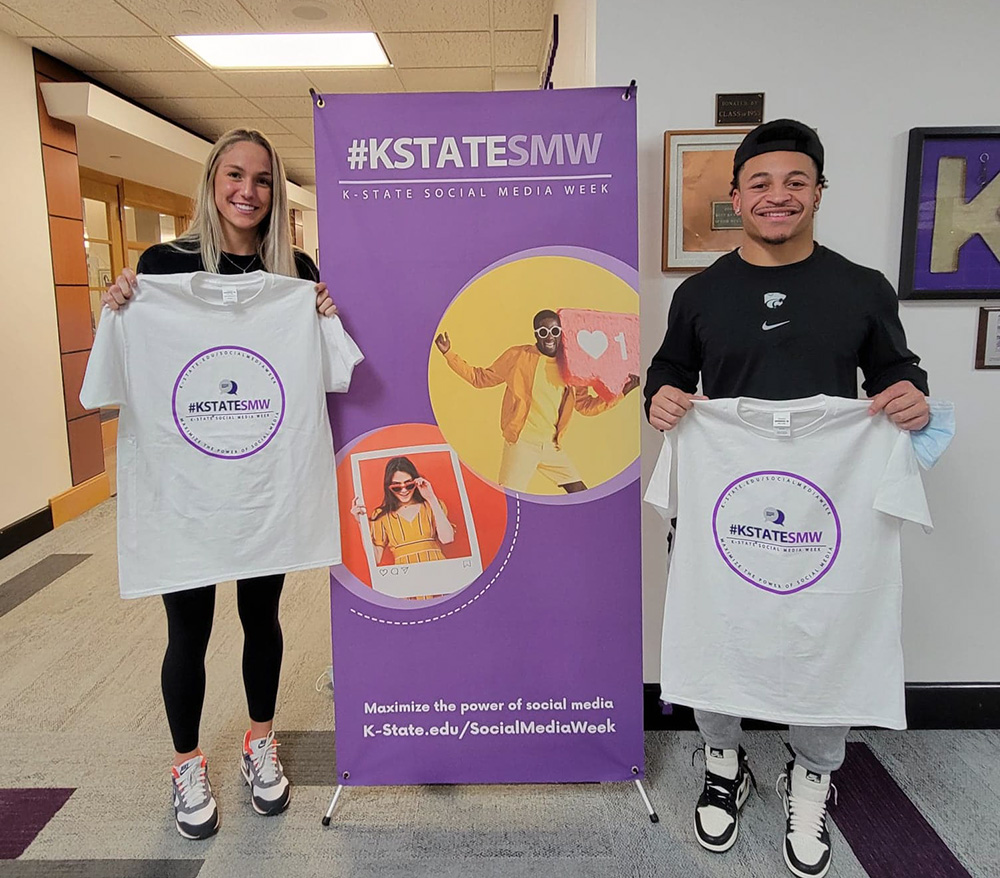 students holding up t-shirts