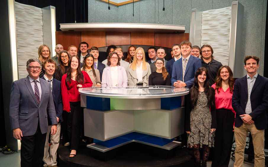 Channel 8 news students and faculty standing on set