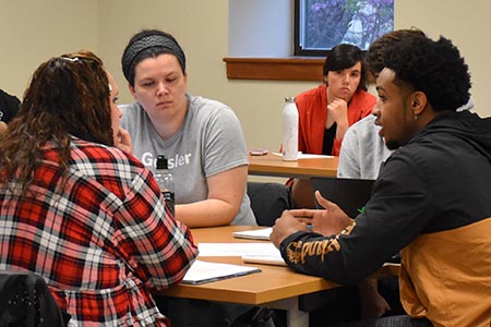 students in a discussion group in the classroom