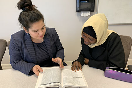 students discussing textbook