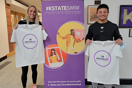 students holding up t-shirts with logos