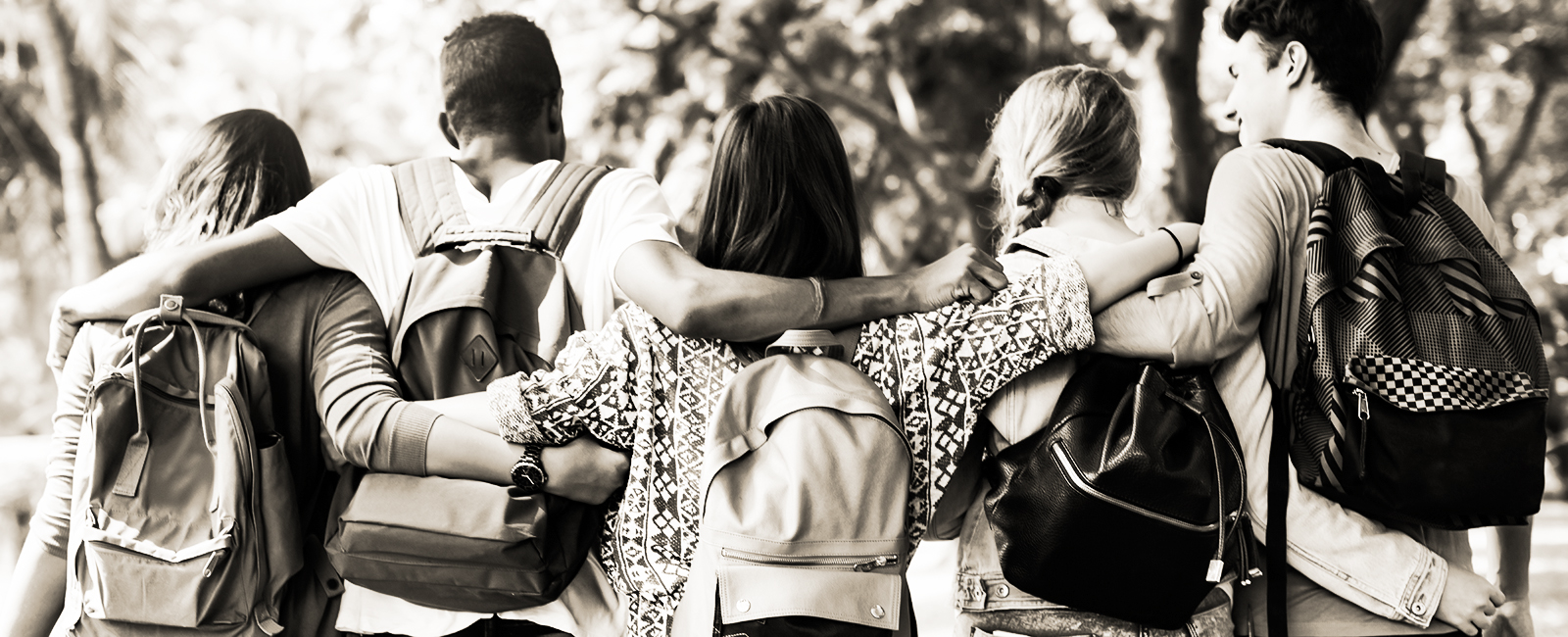 back of students with arms around each other