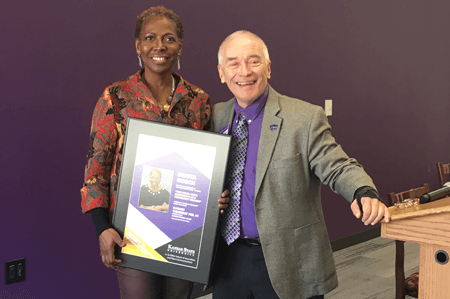 man and woman holding framed poster