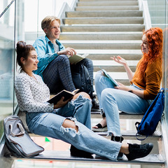 3 students talking in a stairwell