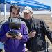 Jason Ford, Kansas State University May 2018 graduate in unmanned aircraft systems, left, and Travis Balthazor, unmanned aircraft systems flight operations manager with the Kansas State University Polytechnic Campus, fly an unmanned aircraft above a tallgrass prescribed burn to gather air quality data. | Photo credit: David Burchfield, Kansas State University