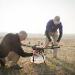 Mike Kuni, Kansas State University senior in the unmanned aircraft systems program, left, and Travis Balthazor, unmanned aircraft systems flight operations manager with the Kansas State University Polytechnic Campus, make final preparations to an unmanned aircraft before flying it into the smoke above a tallgrass prescribed burn. The researchers have attached sensors on unmanned aircraft to gather air quality data during a burn. | Photo credit: Kansas State University