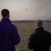 Two Kansas State University pilots fly an unmanned aircraft over a tallgrass prairie prescribed burn to gather smoke emissions data. The pilots are part of a large collaborative project that is using unmanned aircraft to improve the Kansas Flint Hills Smoke Management Plan and determine smoke constituents. | Photo credit: David Burchfield, Kansas State University
