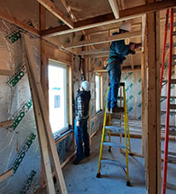 Students in Kansas State University's Net Positive Studio work on assembling the zero energy home in St. John.