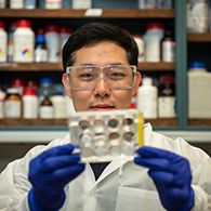Taeyong Kwon holds up a lab sample. 