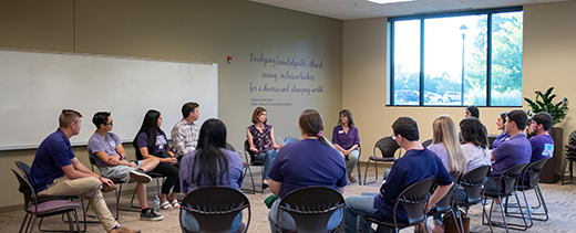 Emily Lehning, director of the presidential regional community visit initiative, center, leads a discussion during the weekly class with the Connected 'Cats student leaders.
