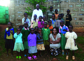 Muturi with Kenyan children orphaned by HIV/AIDS