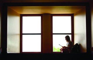 student in Hale Library window